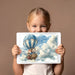 An imaginative playroom wall featuring the elephant pilot mural with soft blue and white decor.