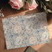 Botanical peony pattern wallpaper featured on a bedroom accent wall behind a bed.