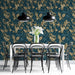 A formal dining room featuring a classic damask wallpaper wall behind an antique dark wood dining table.