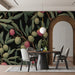 Elegant dining room with olive grove mural wallpaper paired with warm brass lighting and dark wood furniture