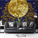 A quiet reading nook styled with deep navy and gold tree wallpaper for a mystical atmosphere.