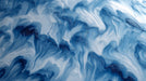 Abstract wallpaper pattern featuring swirling fluid brushstrokes in navy, cobalt, and frosty white tones.