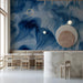 Modern home office with a dramatic abstract blue wave wallpaper focal point and minimalist furniture.