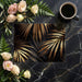 Tropical metallic leaf wall mural in an elegant dimly lit dining room