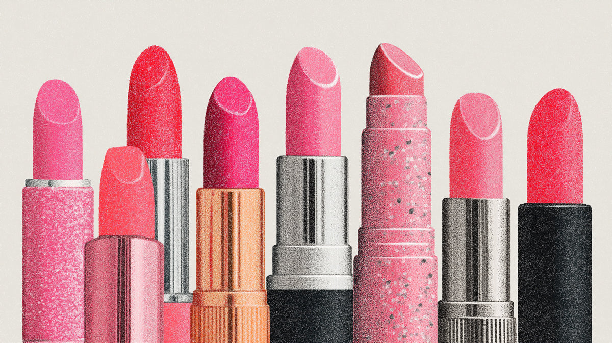 A graphic wallpaper pattern of colorful pink and coral lipstick tubes with metallic casings on a light background