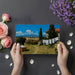 Scenic rural village wallpaper applied to a bedroom wall, creating a calming countryside retreat.