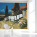Mediterranean landscape mural installed in a light-filled dining room with rustic wooden furniture.