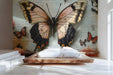 Vintage butterfly and rose mural installed in a cozy bedroom with light oak furniture.