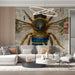 A home study featuring the bee blueprint wallpaper as a focal point behind an antique wooden desk.