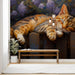 Cozy nursery room featuring a sleeping tabby cat mural on the wall with soft lighting