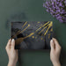 Elegant home office with a dark charcoal and gold splatter wallpaper focal wall
