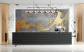 Modern living room featuring a gold drip mural behind a charcoal gray velvet sofa and minimalist coffee table.