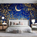 A moody bedroom featuring a dark blue moon and golden foliage mural behind a plush velvet headboard.