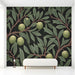 A moody home office interior showcasing a dark olive botanical mural wall behind a classic desk.