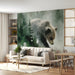 A cozy nursery featuring a large misty forest bear mural behind a wooden crib.