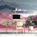 Study featuring a serene mountain range wall mural as a decorative focal point behind a minimalist sofa.