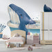 Whimsical whale mural installed in a bright modern nursery room