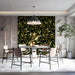 A sophisticated dining room featuring an olive branch wallpaper wall behind a dark wooden table.