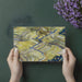 Home office wall decorated with a fluid, painterly terraced landscape wallpaper design.