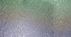 Macro photograph of delicate soap bubble foam in sage green and lavender gradients