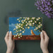 Cozy office space featuring a serene magnolia tree and dog mural on a focal wall behind a wooden desk