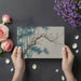 Elegant chinoiserie style wall mural behind a dining room table with neutral decor