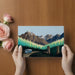 A creative home office space with a scenic mountain wallpaper mural, adding inspiration to the workspace.