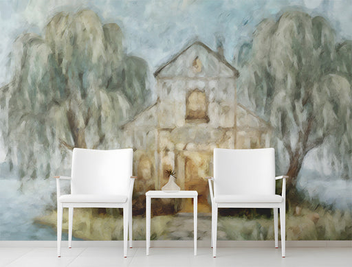 A cozy reading nook featuring the lakeside chapel mural wallpaper, styled with a plush armchair and warm ambient lighting.