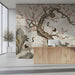 Living room interior featuring an elegant crane and blossom wallpaper mural above a modern neutral sofa.