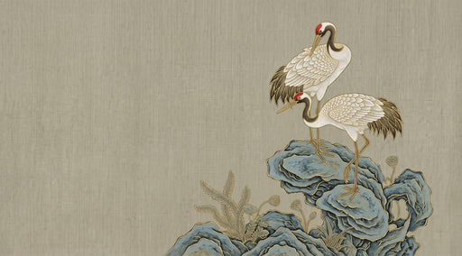 Elegant wallpaper mural with two cranes perched on blue and slate grey rocks against a warm oatmeal linen texture background.