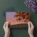A quiet reading nook with the autumn landscape wallpaper creating a peaceful escape.