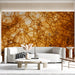 A moody dining room wall featuring the intricate bronze and ochre cellular mural design.