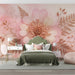 A relaxing bedroom with pink-toned floral wallpaper and elegant cream furniture.