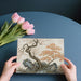 A sophisticated home office interior with a Japanese-inspired landscape wallpaper mural on the main wall.