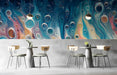 A modern cafe featuring the blue fluid art mural behind a sleek dark sofa.
