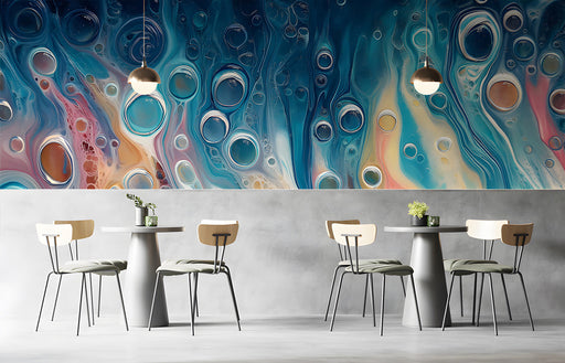 A modern cafe featuring the blue fluid art mural behind a sleek dark sofa.