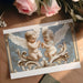 Sophisticated dressing room wall covered in the cherub mural with vintage mirrors and gold accents