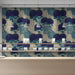 Modern bedroom featuring blue chrysanthemum floral wallpaper behind a wooden headboard