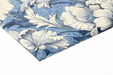 Traditional patterned peony wallpaper in a light-filled living room with white moldings.