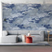 Serene home office space with blue and white wave patterned wallpaper and wooden desk
