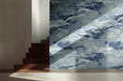 Modern hallway featuring blue chrysanthemum wave mural wallpaper behind a white upholstered headboard