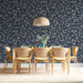 A refined dining room decorated with classic navy and grey floral scroll mural.