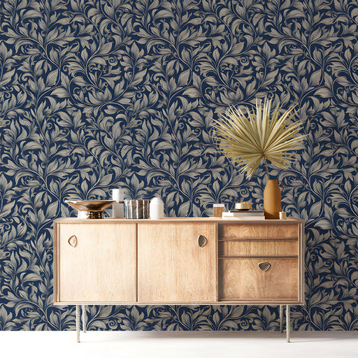 A sophisticated entryway with navy floral wallpaper behind a tufted headboard.