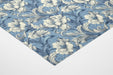 A cozy bedroom interior featuring traditional blue and white floral mural wallpaper.