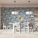 A sophisticated home office space with ornate blue vintage floral wallpaper.