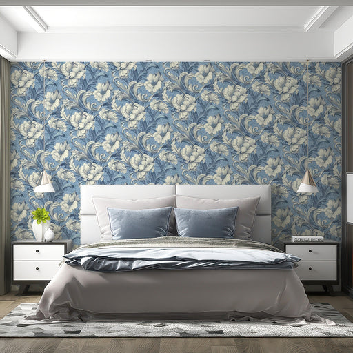 A formal bedroom decorated with blue floral damask wallpaper behind a velvet sofa.