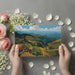Scenic mountain landscape wallpaper displayed in a quiet home office with a wooden desk.
