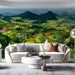 Artistic panoramic wall covering in a living room featuring stylized nature illustrations and rolling fields