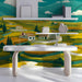 The landscape mural installed on a large living room feature wall behind a mid-century modern sofa.