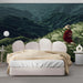 A cozy bedroom featuring a sweeping mountain landscape mural as a focal point behind the bed